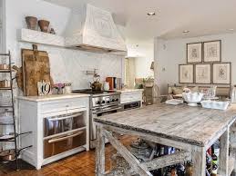 Above the island are two unique, silver pendant lights situated behind an exposed wood header. Friday Favorites The Charm Of French Farmhouse Kitchens