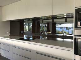 Nothing warms a kitchen quite like a stunning backsplash. Black Mirror Splashback Kitchen Nz Kitchen Wall Tiles Design Kitchen Design Decor White Modern Kitchen