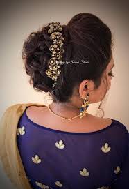 So, to avoid all that hassle, simply bun your hair in a fluffy bun. Bridal Updo For Reception By Swank South Indian Bride Bridal Hair With Accessory Hair Bun Bridal Hair Buns Indian Wedding Hairstyles Hair Styles