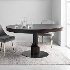 A circular dining table that expands when rotated. Turned Pedestal Expandable Dining Table