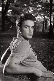 Male Senior Outdoor Portraits Session As He Leans Against A Table In The Middle The Woods Photography Poses For Men Senior Boy Photography Male Portrait Poses