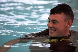 Pfc. Samuel Hudson, a U.S. Army Reserve cadre, warms