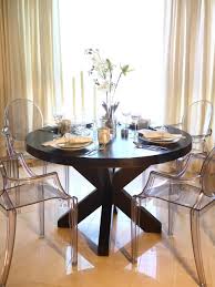 This Elegant Dining Room Features A Large Round Wood Dining Table With Clear Plastic Louis Xvi Round Wood Dining Table Dining Room Table Round Dining Room Sets