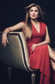 Anna netrebko had a different glamorous 'costume' that was appropriate for her character's appearances in the three acts whilst everyone else was in modern dress. Taking Flight