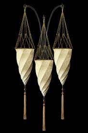 The name of this fortuny scheherazade 2 tiers geometric silk lamp with metal ring reflects the atmosphere it creates: Silk Lamps Fortuny