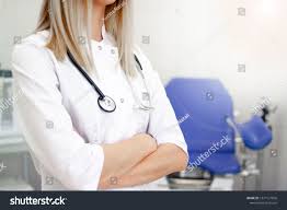 Professional Medical Physician Gynecologist Doctor In White Uniform In Clinic Hospital Gynecological Cabinet With Chair With Images Womens Health Gynecologists Doctor In