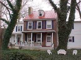 Copper colored metal is designed to mimic the look of an old copper roof. Metal Roof On Red Brick House Online Roof Design
