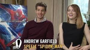 There might also be hosiery, hose, street, city scene, urban setting, well dressed person, suit, pants suit, and pantsuit. The Amazing Spider Man 2 Interview Andrew Garfield Emma Stone Jamie Foxx Pathe Youtube