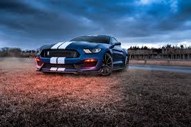 Hear the roar of a mustang as the ground starts to tremble and your legs start to shake. Blue Car Ford Ford Mustang Wallpaper Background Image Ubackground Com