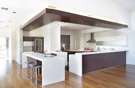This is large kitchen space combines two wood finishes to achieve this unique look. 20 Brown Kitchen Cabinet Designs For A Warm Natural Look Coppell House Kitchen Columns Kitchen Cabinet Design Modern Kitchen