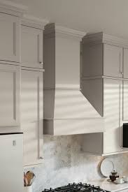In a wall cupboard at eye level. Square Wood Hood Tall Chimney Aristokraft Cabinets