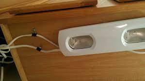 Concealing your lighting helps hide unsightly wiring and can help redirect the lighting downwards to higher usage countertop areas, which can be helpful in a kitchen. Screw Paper Clips Under Cabinets To Hide Under Cabinet Lighting Wires Under Cabinet Lighting Cabinet Lighting Garage House