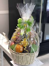 A charming wooden handled basket holds an inspirational arrangement of flowers for sending your best wishes and loving thoughts. Fruit Basket Fruit Basket Gift Fruit Baskets Diy Fruit Gifts