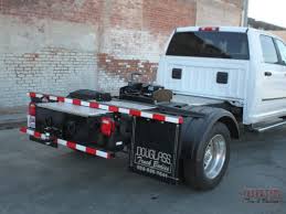 The front edge of the trailer extends over the rear bumper of the pickup truck. Douglass Hotshot Hauler Douglass Truck Bodies