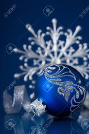 These blue hued christmas ornaments will add that unique color to your holiday display or christmas tree, capturing everyone's attention. Blue And Silver Christmas Ornaments On Dark Blue Xmas Background Stock Photo Picture And Royalty Free Image Image 32729244