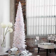 Pencil Christmas Tree Ideas A Festive Space Saving Solution Upright female legs in skinny jeans and bright knitted socks on a bright bed against the background of the christmas tree. pencil christmas tree ideas a festive