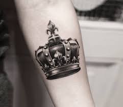 Ideas for women's crown tattoos include a small tiny simple crown, intricate patterns of crown, crowns with rhinestones, crown with initials, crown as a part of engagement ring tattoo and many more. Crown Tattoo By Guillaume Martins Photo 30611
