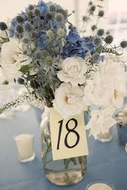 From there, the team crafted a reception table, complete with a beautiful towering centerpiece growing from the center of the table. Dusty Blue Grey Wedding Ideas Blue Wedding Flowers Wedding Centerpieces Wedding Flowers Wildflowers