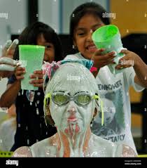 Eisenhower Elementary School kindergartners Karen Espirtu, 5, and Michelle  Hernandez, 6, get ready to pour green slime