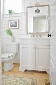 The blue pairs nicely with the white and gray marble surfaces, and the small touches of warmer colors and materials keep the space from feeling too chilly. Painting Bathroom Cabinets A Beginner S Guide Chrissy Marie Blog