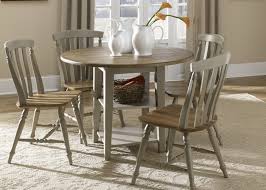 The open bottom shelf provides an interesting visual while providing useful storage space. Drop Leaf Leg Round Dining Table With Solids Rubberwood Driftwood Taupe Finish