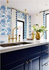 Dark blue kitchen cabinets with brass hardware. Brass Hardware Making A Comeback Against Navy