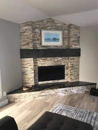 A contura i7 insert wood stove with split faced slate tiled chimney breast, slate tiled hearth and log storage within the fireplace in southchurch, essex. Elemental Builders Inc Split Face Stone Fireplace Facebook