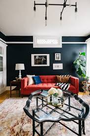 A moody dark blue can be used to make a large living room feel more intimate whilst a punchy royal blue living room channels a modern aesthetic. Deja Blue This San Francisco Living Room Gets A Makeover The Everygirl Red Couch Living Room Red Sofa Living Room Couches Living Room