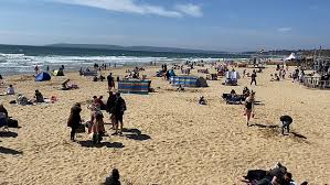 Clean and tidy, bournemouth beach features a long stretch of sand lapped by gentle blue waves. People Enjoy Sunny Weather On Bournemouth Beach Metro Video