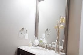 Thanks to decoart for helping sponsor this project by providing the paint used on my bathroom vanity and diy mirror frame. Frame A Builder Grade Mirror Why You Should And What To Do With Those Clips Love Remodeled