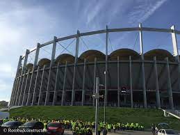 In the exterior tall concrete columns dominate the image, giving a distinctive rhythm to the arena. Arena Nationala Rombadconstruct