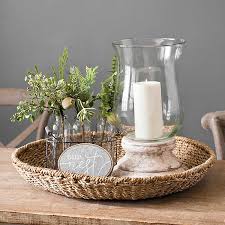 While decorating a round coffee table, many people suggest grouping objects into a triangular shape. Seagrass Round Decorative Tray Kirklands