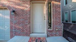 What does teal front door mean? Panorama Frame White Entrance Door With Welcome Mat To A Brick Stock Photo Picture And Royalty Free Image Image 137678991
