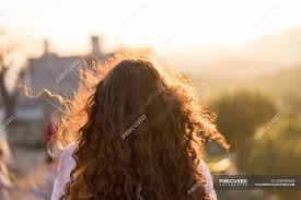 Chopped straight pixie back view. Back View Of Young Woman With Long Curly Hair At Sunset Brown Hair Building Stock Photo 258939948