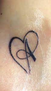 The design below has symbols of the heart and letters that definitely carry some deep meaning for the wearer. Tatoo Love Letter A Alphabet Tattoo Designs Tiny Heart Tattoos Tattoo Alphabet