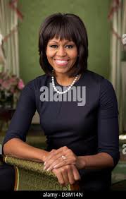 First lady Michelle Obama sits with Emily, left, and Sarah Buder, authors  of "Letters to a Bullied Girl: Messages of Healing and Hope" as President  Barack Obama speaks at a conference on
