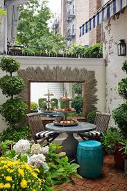 Small bouquets of roses dot the table. Pinterest Small Courtyard Garden Ideas