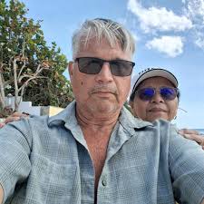 What is the location of the beautiful beach in the Cayman Islands?