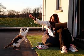 Cynthia Burrell, a massage therapist whose home-based business has been  shuttered in the coronavirus disease (COVID-19) outbreak, feeds her chicken  Speck in her backyard in Seattle, Washington, U