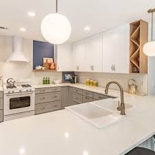 In this modern cooking space featured on harvey maria, chartreuse green and turquoise pop against the pale cabinetry and retro, white dining set. Crystal And Aron Cabinet Depot