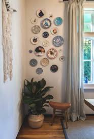 Gold plate on dark wooden background. Ceramic Plates Hanging Wall Decor Ideas Ecemella