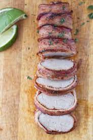 Grill the pork over direct medium heat, with the lid closed, until the meat is barely pink in the center and the bacon is fully cooked, 10 to 13 minutes, turning once. Traeger Bacon Wrapped Pork Tenderloin A License To Grill