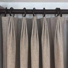 We selected tailored pleat luxe linen in alabaster paired with satin black hardware to complement her black metal framing. Pleat Guide Rainbow Draperies Shop