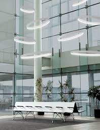 Cascading Circular Pendants Of Varying Sizes In High Ceiling Atrium Space High Ceiling Lighting Commercial Lighting Fixtures Circular Lighting