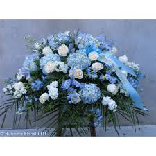 The casket, whether it be open or closed, becomes the symbolic vessel for this important exchange. Pale Blue White Casket Spray Rubrums Florist Ossining Ny Florist Best Local Flower Shop