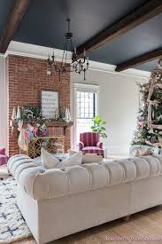 A circular brick pattern adds to the wagon wheel effect of the ceiling beams. Vintage Living Room Black Ceiling Brick Fireplace Dark Wood Beams Anthropologie Home Tufted Sofa Christmas 2 Of 23 Addison S Wonderland