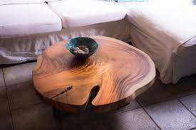 Antique glass a round glass top and a distressed golden base perfectly complement bright blue french art deco chairs in this upstate new york farmhouse. Tree Trunk Coffee Tables Unik Living Unique Coffee Tables
