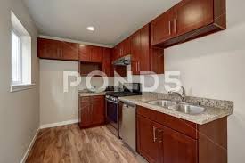 But its good looks only add to the advanced functionality the the veneer is thin, be careful not to scratch and i plan to put glass on top to preserve the finish. View Of Burgundy Kitchen Cabinets With Granite Counter Top Stock Images Page Everypixel