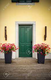 You can open up the energy by directing the eye to the. Wooden House Front Door With Large Flower Pots Close Up Stock Photo Picture And Royalty Free Image Image 137795813