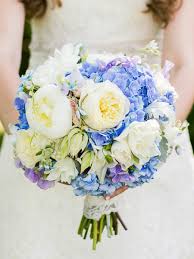 The sunny shades and moody anemones mixed to create a complex clutch. The Best Blue Wedding Flowers And 16 Gorgeous Blue Bouquets